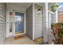 Inviting front porch with a storm door, white columns, and a welcoming 'hello' doormat at 3724 W 42Nd Ter, Indianapolis, IN 46228