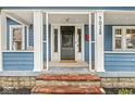 Inviting front porch featuring classic architectural details and a brick entry at 5028 Graceland Ave, Indianapolis, IN 46208