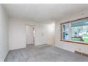 Bright and airy living room featuring neutral paint, large windows, and carpeting at 5734 Hillside Ave, Indianapolis, IN 46220
