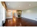 Bright living room with stone fireplace, hardwood floors and large window with valance at 6047 W 56Th St, Indianapolis, IN 46254