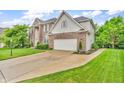 A lovely two-story home featuring brick and vinyl siding, a paved driveway, and an attached two-car garage at 6071 Sugar Pine Dr, Avon, IN 46123