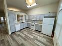 Well-lit kitchen featuring modern appliances, ample cabinet space, and stylish vinyl floors at 6083 White Birch Dr, Fishers, IN 46038