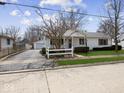 Quaint one-story home with a charming front porch, complemented by a detached garage at 625 7Th St, Shelbyville, IN 46176
