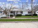 Charming single-story home with a cozy covered front porch and manicured lawn at 625 7Th St, Shelbyville, IN 46176