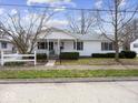 Charming single-story home with a cozy covered front porch and manicured lawn at 625 7Th St, Shelbyville, IN 46176