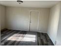 View of a vacant living room with wood-look flooring and a gray rug at 635 Laclede St, Indianapolis, IN 46241