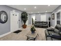 Spacious living room featuring modern gray walls, plush carpeting, and comfortable leather furniture at 725 N Sheffield Ave, Indianapolis, IN 46222