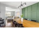 Open-concept dining area featuring a wooden table, stylish chairs, and modern lighting fixture at 7914 Cardinal E Cv, Indianapolis, IN 46256