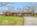 Charming brick home with a well-manicured front yard and long driveway at 7915 Allisonville Rd, Indianapolis, IN 46250