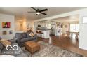 Open living room with modern ceiling fan, and opens to the kitchen and dining areas at 7915 Allisonville Rd, Indianapolis, IN 46250