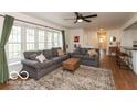 Bright living room with large windows, ceiling fan, and cozy furniture at 7915 Allisonville Rd, Indianapolis, IN 46250