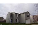 Two-story home with light-gray siding, white trim, blue front door, and an attached garage at 796 Hickory Pine Dr, Whiteland, IN 46184