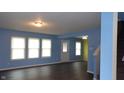 Bright living room boasts fresh paint, new floors and plenty of natural light from windows at 796 Hickory Pine Dr, Whiteland, IN 46184