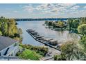 Expansive aerial view of waterfront homes with private docks along a tranquil lake surrounded by lush greenery at 9769 Marina Village Dr, Indianapolis, IN 46256