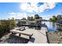 Picturesque dock with boat lifts on a clear lake, surrounded by trees and scenic views under a sunny sky at 9769 Marina Village Dr, Indianapolis, IN 46256