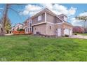 This home has a lovely backyard with a wood deck, lush green lawn, and mature trees at 10157 Woods Edge Dr, Fishers, IN 46037