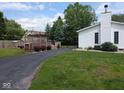 A spacious backyard with a wooden deck, patio, and lush lawn at 1024 Foltz St, Indianapolis, IN 46241
