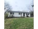 Charming single story home featuring a well-maintained lawn and black shutters at 1024 Foltz St, Indianapolis, IN 46241