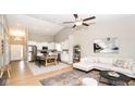 Open-concept living room with vaulted ceilings, seamlessly connecting the kitchen and dining area at 10554 Crystal Coop Ln, Indianapolis, IN 46235