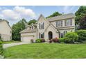 Beautiful two-story brick home boasts a manicured lawn and attached two car garage at 11974 Volcanic Rock Dr, Fishers, IN 46037