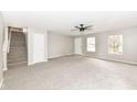 Bright living room features a ceiling fan and staircase at 12455 Deerview Dr, Noblesville, IN 46060