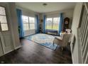 Inviting living room with hardwood floors, bright windows, and stylish blue accents at 1336 Danielle Rd, Lebanon, IN 46052