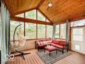 Cozy screened-in porch with vaulted wood ceilings, comfortable seating, and natural light at 13921 Leatherwood Dr, Carmel, IN 46033