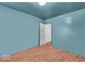 Empty bedroom showcasing hardwood floors and walls painted in a pleasant blue hue at 1441 N Euclid Ave, Indianapolis, IN 46201