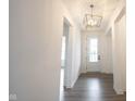 Bright entryway featuring a statement light fixture, hardwood floors, and a view of the home's interior at 15109 Larchwood Dr, Westfield, IN 46074