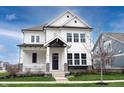 A beautiful two-story home with a charming front porch, stone accents, and a well-maintained lawn at 15591 Heatherbank Dr, Westfield, IN 46074