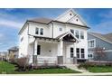 Charming two-story home with a welcoming front porch, crisp white siding, and well-manicured landscaping at 15591 Heatherbank Dr, Westfield, IN 46074