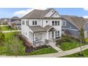 Stunning two-story home showcasing a lovely front porch, lush landscaping, and timeless architectural details at 15591 Heatherbank Dr, Westfield, IN 46074
