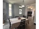 Inviting dining room with a decorative light fixture and views into the living area with a television set at 159 N Lincoln St, Martinsville, IN 46151