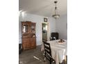 Cozy dining room featuring hardwood floors, vintage cabinet, and view into the kitchen with ample natural light at 159 N Lincoln St, Martinsville, IN 46151