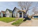 Charming bungalow-style home with blue siding, covered porch, and quaint walkway at 1614 S Talbott St, Indianapolis, IN 46225