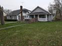 Cozy single-story home with a front porch and ramp, nestled on a well-maintained lawn, with other houses nearby at 1830 Nichol Ave, Anderson, IN 46016