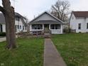 Single-story house with a light-colored exterior, front porch, and accessible ramp leading to the entrance at 1830 Nichol Ave, Anderson, IN 46016
