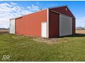 Red and white barn featuring sliding doors and a classic gable roof design on a grassy lot at 2083 E 750 S, Flat Rock, IN 47234