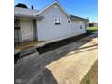 The exterior features a covered front porch and vinyl siding, with a driveway to the side at 2111 Central Ave, Anderson, IN 46016