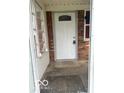 Welcoming entryway with a white front door and brick accents at 2146 Lawrence Ave, Indianapolis, IN 46227