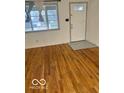 Bright living room featuring hardwood floors and a view of the front door and window at 2146 Lawrence Ave, Indianapolis, IN 46227