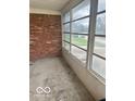 Enclosed patio with brick wall and large windows, perfect for enjoying the outdoors at 2146 Lawrence Ave, Indianapolis, IN 46227