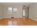 Living room featuring hardwood floors, natural light from a double window, and a doorway to the entry at 218 Demarest Dr, Indianapolis, IN 46214