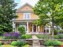 Charming two-story home featuring a covered front porch and professionally landscaped front yard at 2353 Woodcreek Crossing Blvd, Avon, IN 46123