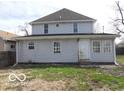 View of the back of the house showing a yard and rear entry door at 2811 S Elm St, Muncie, IN 47302