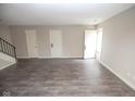 Spacious living room features neutral walls, stairs and modern gray flooring at 2862 Punto Alto Ct, Indianapolis, IN 46227
