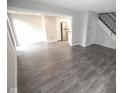 Open concept living room features modern gray flooring and leads into the kitchen area at 2862 Punto Alto Ct, Indianapolis, IN 46227