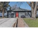 A charming single-story home with a well-kept lawn and a bright red front door at 2938 Hillside Ave, Indianapolis, IN 46218