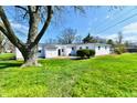 View of back yard, shows two-car garage and back of single story home at 3015 E Sumner Ave, Indianapolis, IN 46237
