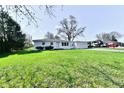Charming single-story home with a well-manicured lawn and an attached two car garage at 3015 E Sumner Ave, Indianapolis, IN 46237